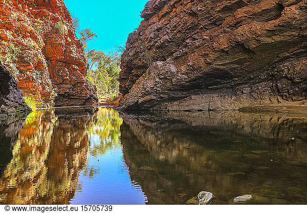 Scenic Simpsons Gap and permanent waterhole reflecting the cliffs in West MacDonnell Ranges  near Alice Springs on Larapinta Trail  Outback  Northern Territory  Australia  Pacific