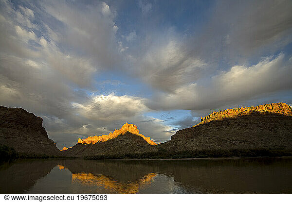 Scenic sunset and clouds and their reflection on the Colorado river  Canyonlands National Park  Utah.