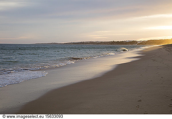 Scenic view of beach against sky during sunset  Atlantic Coast  Algarve  Portugal