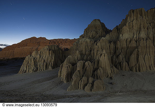 Scenic view of Cathedral Gorge State Park against blue sky at night