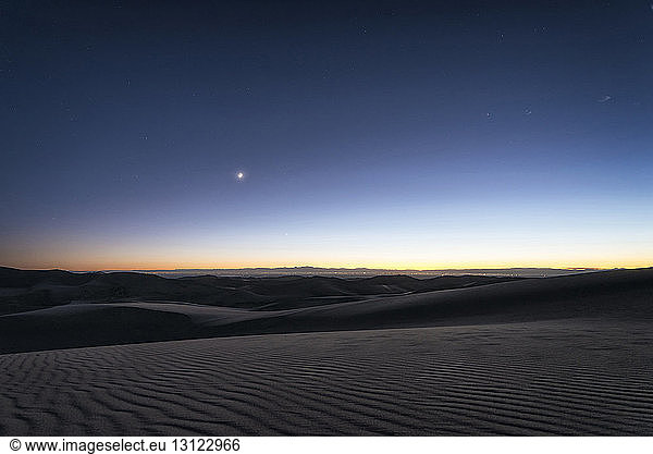 Scenic view of great sand dunes national park during sunset