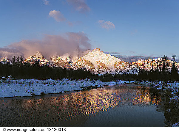 Scenic view of lake against snowcapped mountains
