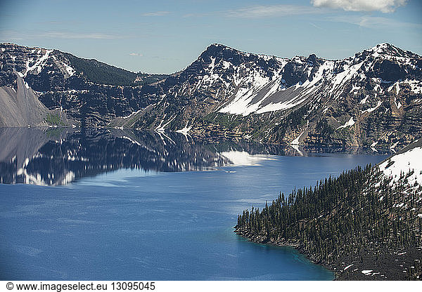 Scenic view of lake amidst mountains at Crater Lake National Park against sky