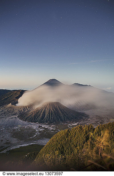 Scenic view of landscape against blue sky at Mount Bromo