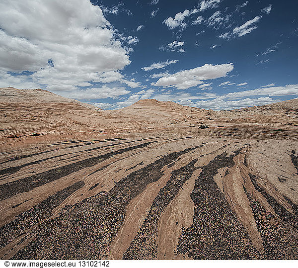 Scenic view of landscape against cloudy sky at Grand Staircase-Escalante National Monument