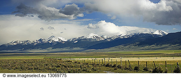 Scenic view of landscape and snowcapped mountain