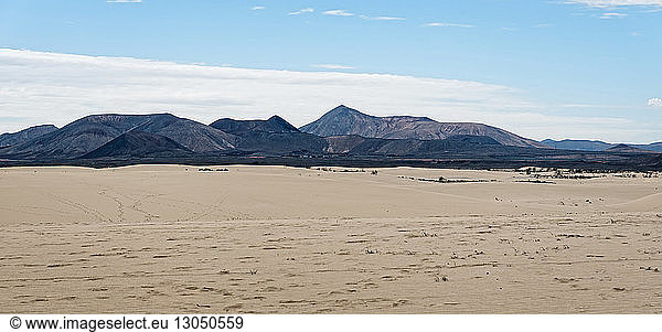 Scenic view of mountain ranges at desert against sky