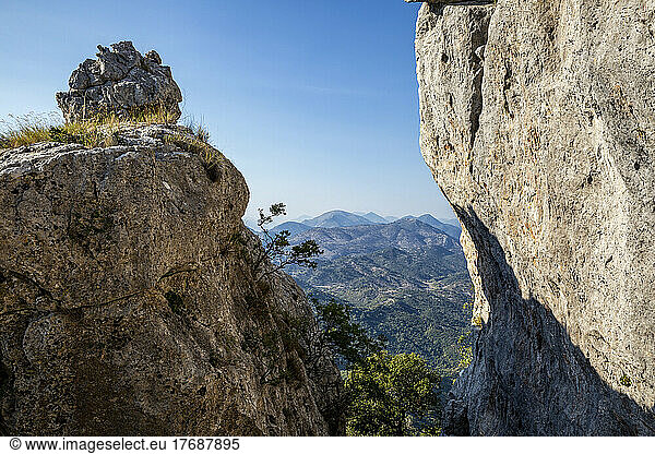 Scenic view of mountains through rocks on sunny day