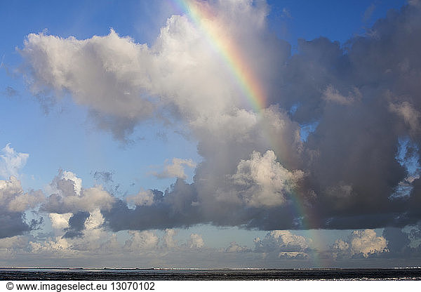 Scenic view of rainbow and clouds