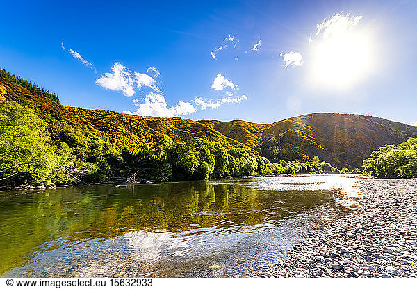 Scenic view of river against sky during sunny day  Motueka Valley  South Island  New Zealand