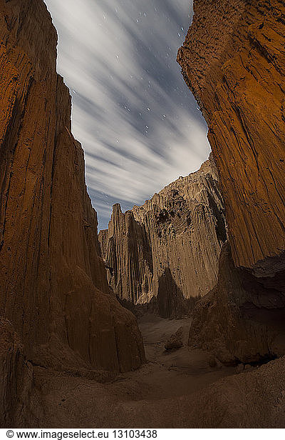 Scenic view of slot canyons against cloudy sky at Cathedral Gorge State Park