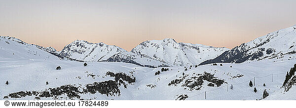 Scenic view of snowcapped Pyrenees mountain range at sunset  Baqueira Beret  Spain