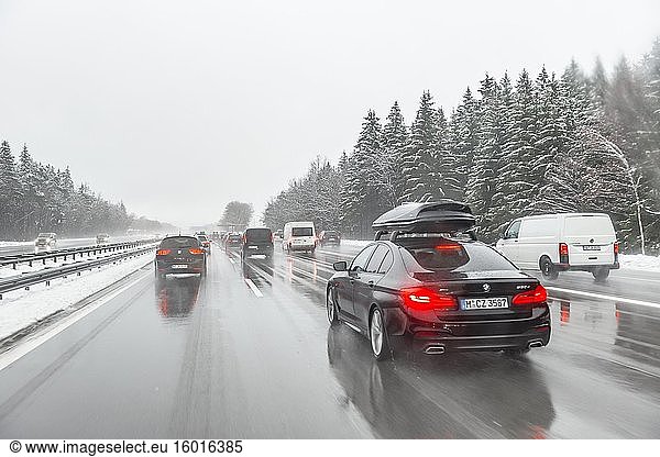 Schlechtes Wetter  dichter Autoverkehr bei starkem Schneefall und Regen auf der Autobahn A8  bei München  Bayern  Deutschland  Europa