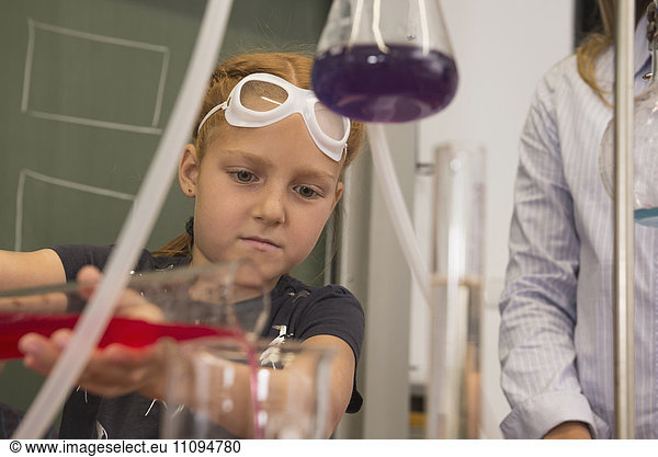 School girl mixing liquid in chemistry class  Fürstenfeldbruck  Bavaria  Germany
