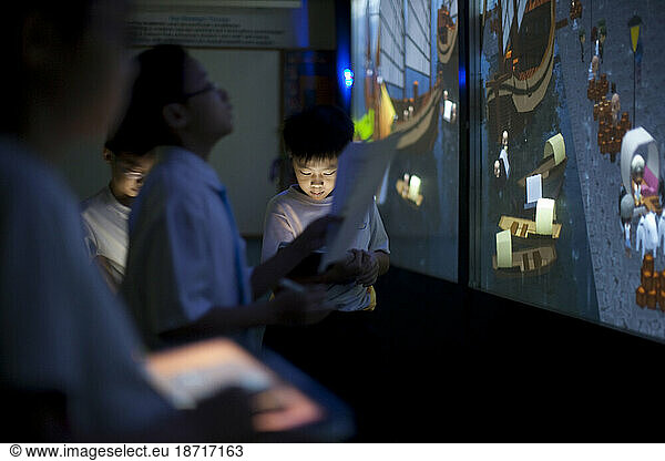 Schoolchildren in Singapore use 4D immersion technology in a computer lab during a summer vacation enrichment class.