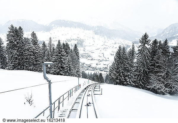 Schweiz  Kanton St. Gallen  Bahnlinie entlang des schneebedeckten Gipfels und des Tals des Chaserrugg-Bergs
