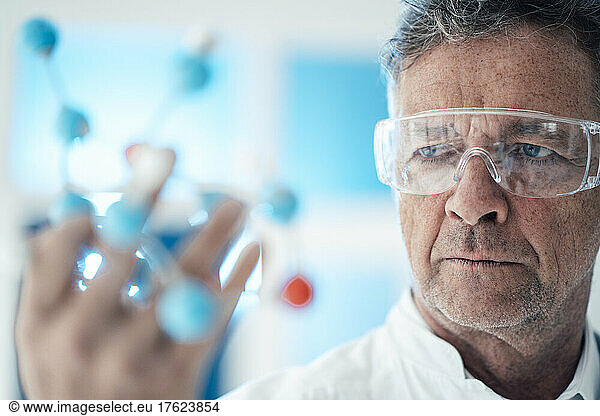 Scientist analyzing molecular structure with protective eyewear