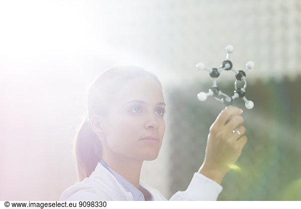 Scientist examining molecule model