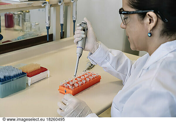 Scientist pipetting samples from eppendorf tubes