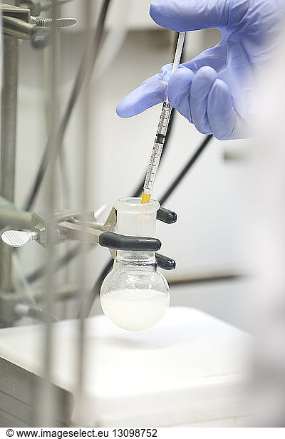 Scientist using pipette in laboratory