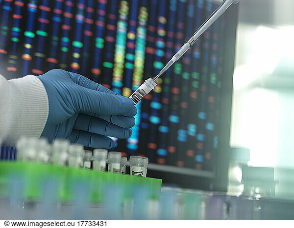 Scientist with pipette evaluating samples in laboratory