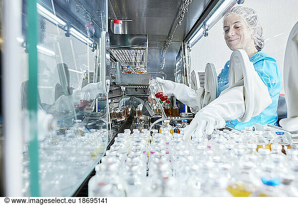 Scientist working in microbiological safety cabinet laboratory