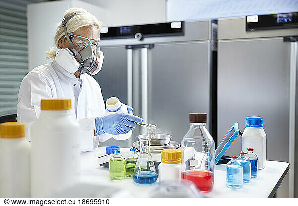 Scientist working with chemicals in laboratory