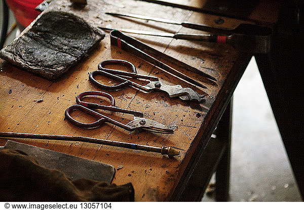 Scissors and tweezers on workbench at workshop
