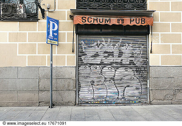Scrum Pub storefront with graffiti on security door  Madrid  Spain