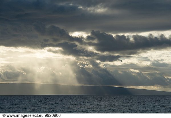 Seascape of storm clouds and sunbeams  Maui  Hawaii