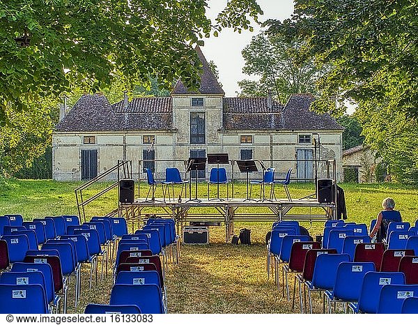 Seating and stage ready for brass band outdoor concert  Allemans-du-Dropt  Lot-et-Garonne Department  Nouvelle Aquitaine  France.