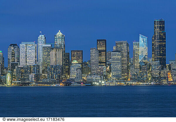 Seattle skyline  from Puget Sound  downtown buildings at night.