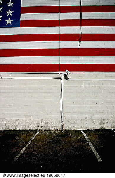 Security camera under American Flag mural.