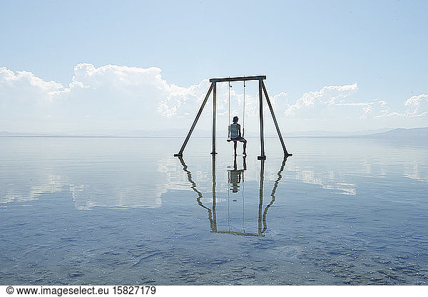 Selbstporträt auf Schaukel in Reflexion über Salton Sea Californi