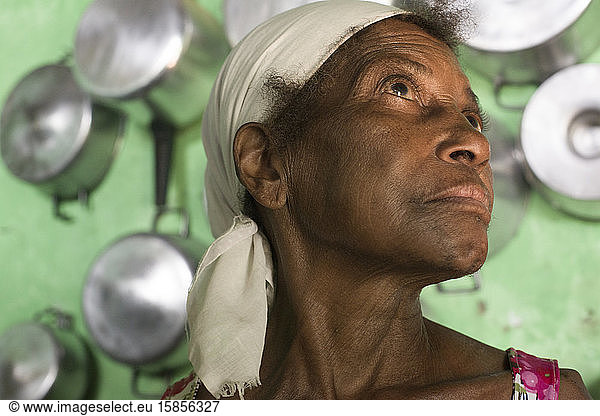 Senior Afro-Brazilian woman in the kitchen of her house