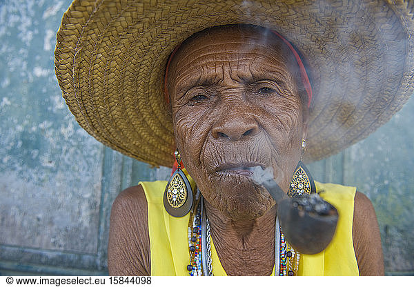 Senior Afro-Brazilian woman smoking pipe