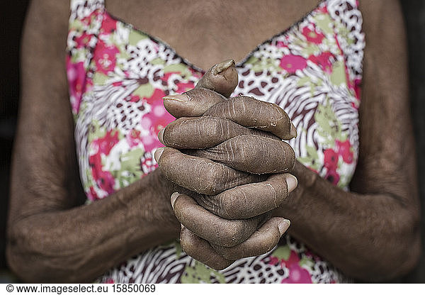 Senior Afro-Brazilian woman with joined hands