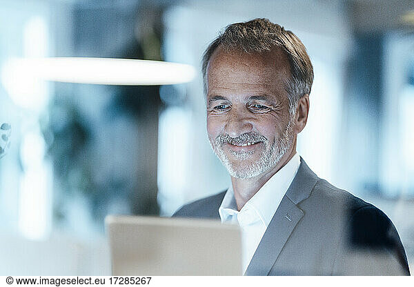 Senior businessman using digital tablet in office