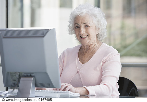 Senior Caucasian businesswoman working at desk