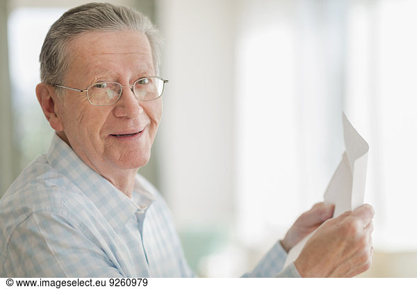 Senior Caucasian man reading letter