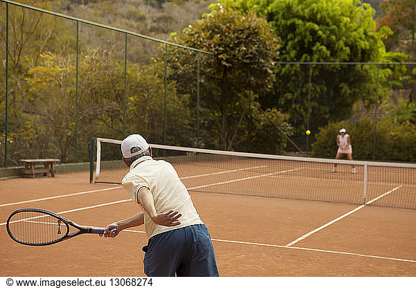 Senior couple enjoying tennis at court