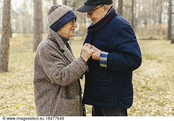 Senior couple holding hands standing at park
