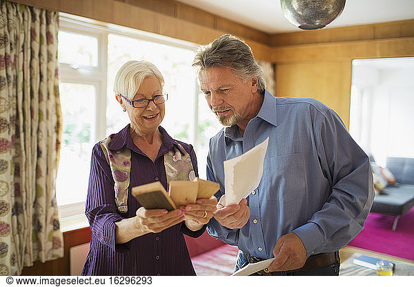 Senior couple looking at wood and paint swatches in living room
