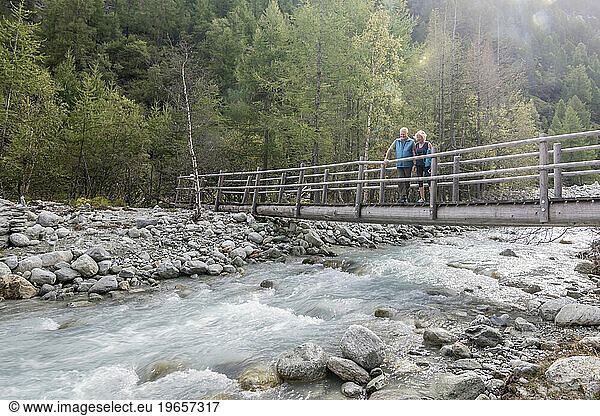 Senior couple on bridge in natural setting  Haute Route Traverse  Valais Canton  Switzerland