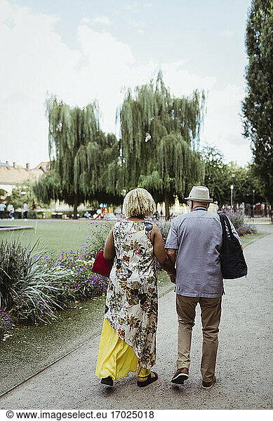 Senior couple spending leisure time in park during vacation