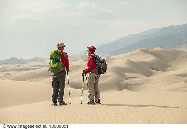 Senior couple talk and enjoy view of sand dunes