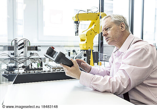 Senior engineer training robot arm with digital control