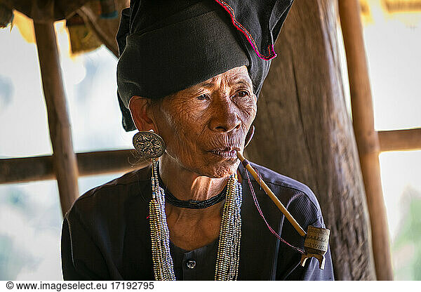 Senior lady of Akhu tribe smoking pipe near Kengtung  Myanmar