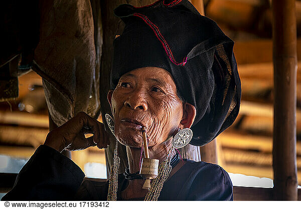 Senior lady of Akhu tribe smoking pipe near Kengtung  Myanmar