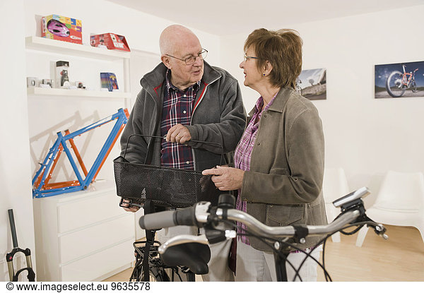 Senior man and woman with electric bicycle